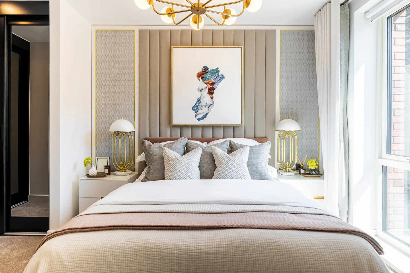 a bedroom with a bed and a chandelier